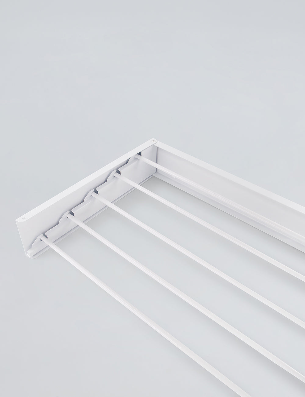 White wall mounted drying rack folded flat against wall